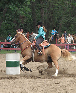 A horse and rider executing a barrel turn.